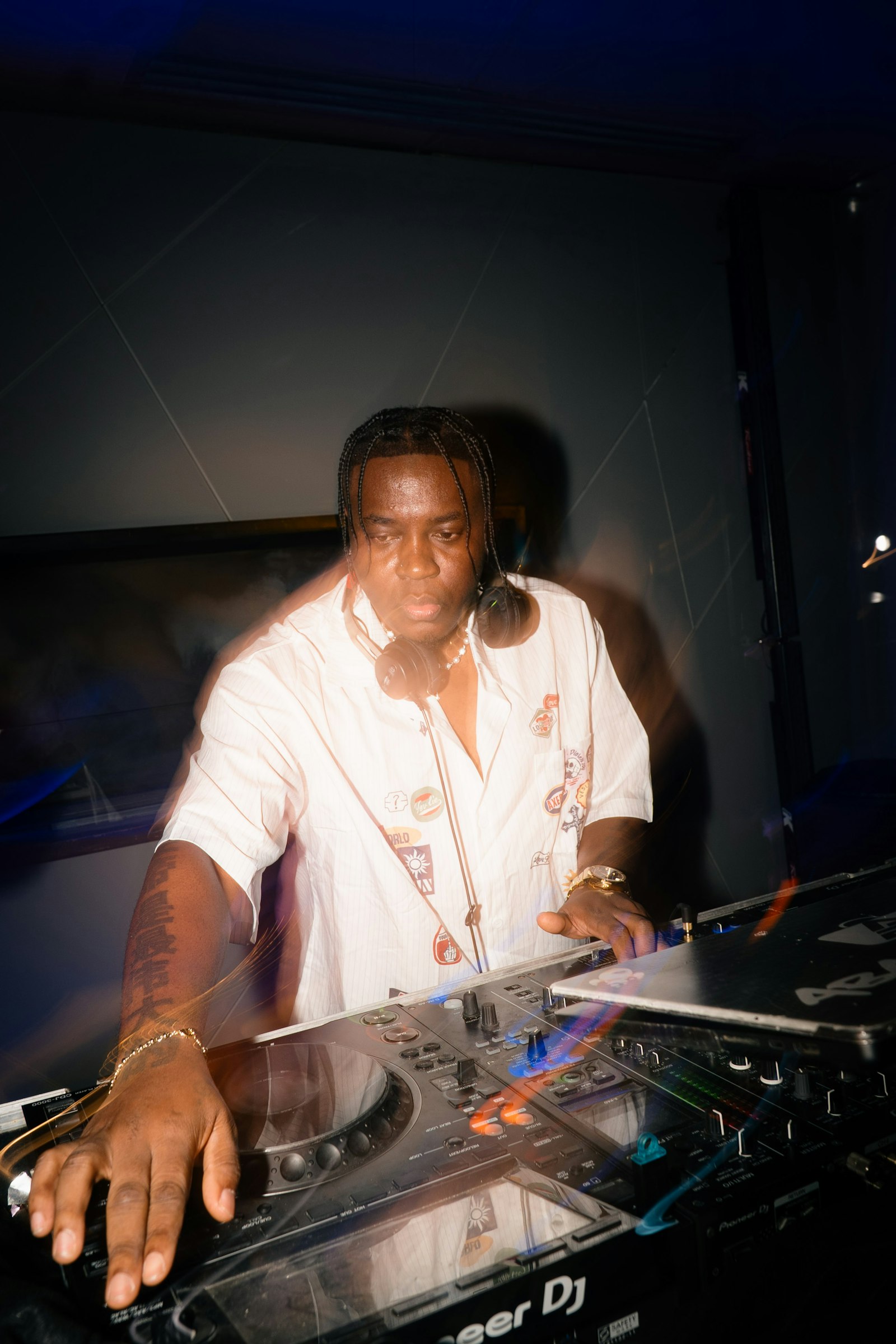 DJ mixing turntables in a nightclub; illustrative stock photo, not Head Trip
